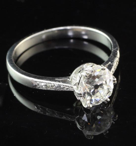 A platinum and single stone diamond ring with diamond set shoulders, size M.